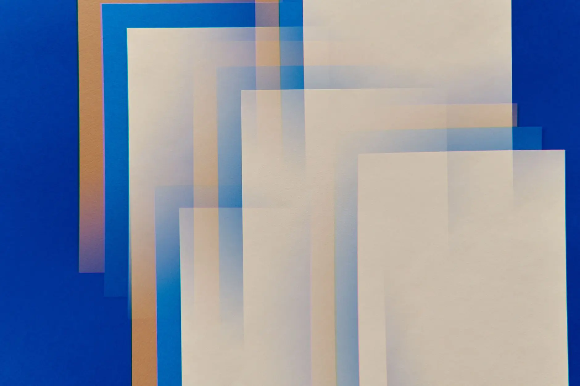 Layered colored paper shapes overlapping in an abstract arrangement